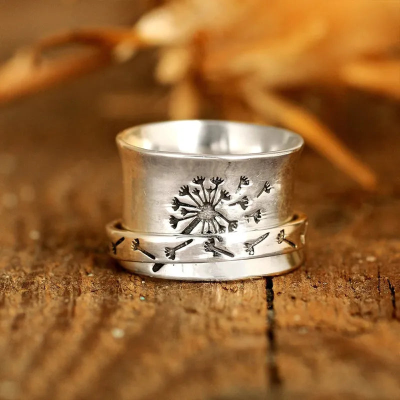 Silver rotatable flower ring showing floral detail and adjustable positioning