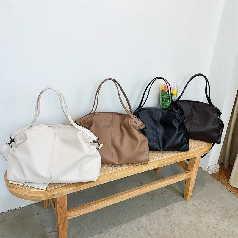 Large soft PU messenger bag in khaki colour with a long shoulder strap, shown open to reveal inner phone pocket.