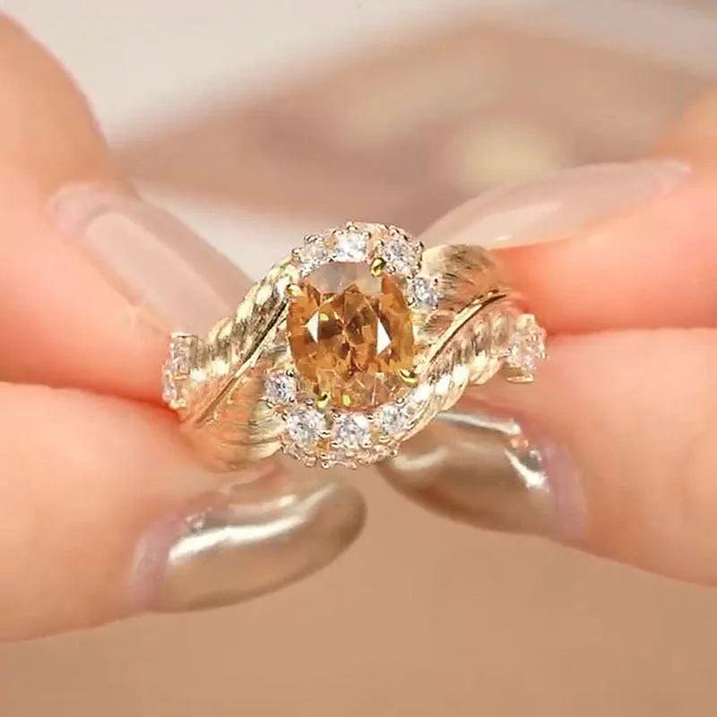 Gold-colour copper women's ring with embossed feather design and inlaid yellow zircon stone