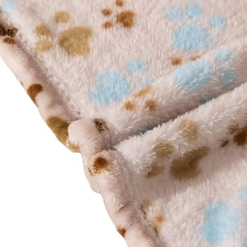 Blue cartoon dog pattern double-sided flannel pet blanket laid flat, showing its size next to a pet crate.