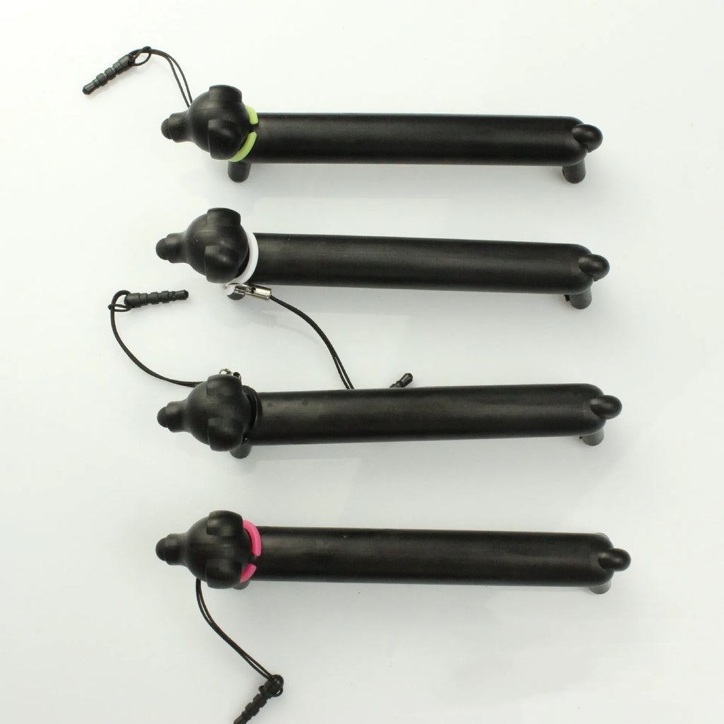 Black dog-shaped touch screen stylus pen shown next to a smartphone on a desk.