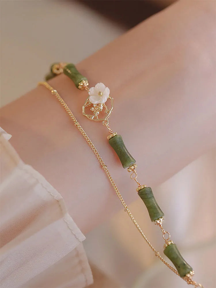Handcrafted green olivine bracelet with double layer twin bells and olive branch design.
