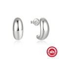 A single C-shaped sterling silver stud earring with a glossy gold or silver electroplated finish.