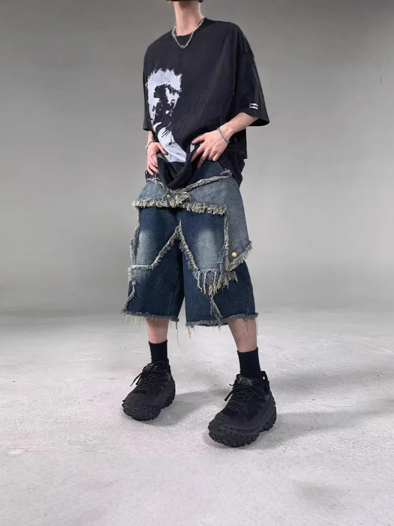 Blue denim shorts with frayed hem and five-pointed star detail, loose fit silhouette