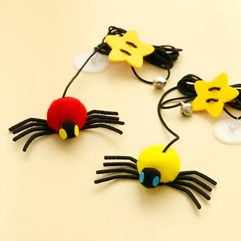Hanging cat toy with feathers, bell and colourful spiders on elastic rope