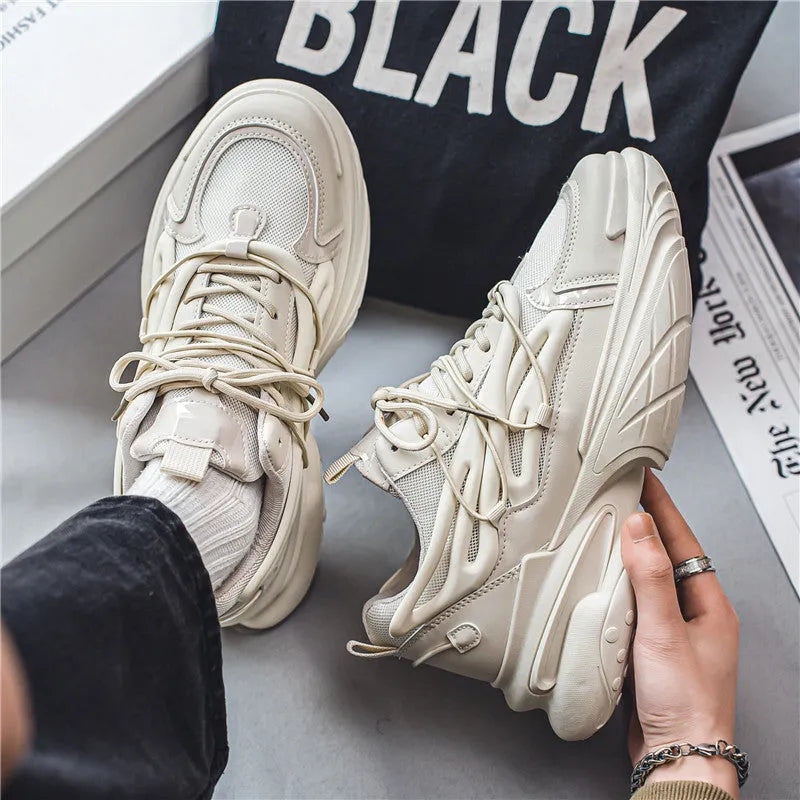 Men's beige and black low-top sneakers with mesh lining, lace-up front, and rubber platform soles